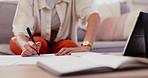 Woman, hands and writing in book for finance, budget planning or documents on living room sofa at home. Closeup of female person or freelancer working on financial accounting, invoices or paperwork