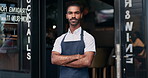 Waiter, man and arms crossed at restaurant for business, welcome or ready for service with confidence. Barista, person and server by entrance of cafe, coffee shop or diner for hospitality and career