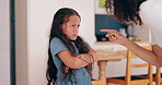 Angry mom, girl child and discipline for writing on wall, shouting and sad for mistake in family home. Kid, mother and daughter with pointing, pencil and talking with drawing in living room at house