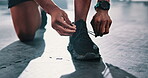 Closeup, gym or hands of person with shoes for training, exercise or workout routine in fitness center. Lace, tie or legs of sports athlete with footwear ready to start practice on studio floor alone