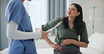 Doctor, patient and woman in a consultation, injury and conversation with nurse and healthcare. Professional, appointment and medical with emergency and treatment with diagnosis and stomach pain