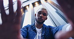 Fashion, hand frame and face of man in city with trendy clothes, modern style and cool outfit on weekend. Confident, pride and portrait of man with palm for photography, selfie and low angle in town