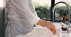 Closeup, person and washing hands for hygiene with water, faucet and stop bacteria by sink in kitchen. Tap, cleaning and home with dirt, dust or germs for virus with rinse, splash or drop in morning
