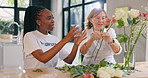 Home, volunteer and old woman with flowers, smile and relaxing with activity, talking and hobby in a living room. Conversation, African person and charity worker with pensioner, senior lady or plants