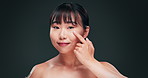 Skincare, hyaluronic acid and face of Asian woman in studio with beauty product, vitamins or facial routine. Smile, anti aging and benefits for girl with oil, serum or dermatology on green background