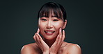 Skincare, woman and korean beauty on face in studio with confidence and pride from dermatology. Happy, girl and smile for healthy glow on natural skin from facial or cosmetics in dark background