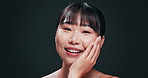 Korean, skincare and face of happy woman with beauty in studio with confidence and pride from dermatology. Healthy, girl and smile with natural glow on skin from facial cosmetics in dark background