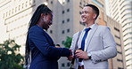 Business woman, man and handshake in street, introduction or greeting with respect with smile in city. People, friends or staff with shaking hands, kindness and welcome with agreement, deal or thanks