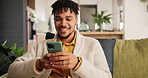 Smile, cellphone and young man networking on social media, mobile app or the internet on sofa at home. Happy, technology and male person scroll on website with phone in living room at apartment.