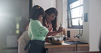 Mother, daughter and mixing bowl in kitchen with baking, happy and teaching for child development. Family, woman and girl kid with cooking, flour and learning for cookies, cake and dessert in home 