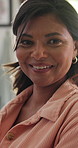 Smile, face and mature woman at her home relaxing with positive, good and confident attitude. Happy, laughing and portrait of Indian female person chilling in living room of apartment or house.