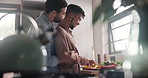 Gay couple, cooking food and hug in kitchen, love and bonding together. Lgbtq men, romance and embrace in home, cutting vegetables and smile in preparation for organic healthy salad on valentines day