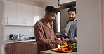 Happy man, gay couple and cutting vegetables for food, cooking or preparing meal together in kitchen at home. Male person, lovers or LGBTQ relationship making healthy snack for nutrition at house