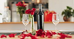 Wine, glass and dinner on valentines day for celebration of love, anniversary or honeymoon in still life. Flowers, romance and elegant date in dining room of home for event, milestone or occasion 