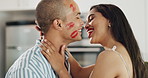 Happy couple, love and kiss with lipstick for fun date and playful at home in intimacy, romance and valentines day. Lover, woman and man in kitchen or house with lip print on cheek for anniversary