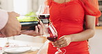 Couple, hands and pour red wine for celebration of love, romance and valentines day on anniversary. People closeup on date with champagne bottle, glasses and drinks for toast, success and luxury