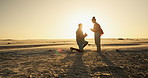 Happy couple, beach and sunset proposal with yes, excited and jump for date, romance and celebration on valentines day. Excited woman and man hug and kiss by ocean for engagement, love and success 