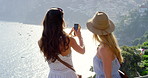 Two friends taking selfies on a mobile phone on a sunny day during their vacation in Italy5