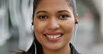 Mixed race woman smiling standing alone in the city