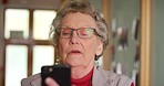 Senior woman with glasses and smartphone with funny video online or reading social media app. Retirement networking, learning and connection of elderly person typing on mobile tech or internet search