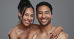 Couple, smile and care for skincare, happy and portrait for wellness in studio by gray background. Happy people, dermatology and hug for cosmetics, hydration and glow or love for skin treatment