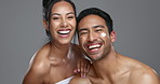 Couple, smile and love for skincare, happy and portrait with moisturizer in studio by gray background. Happy people, dermatology and hug for cosmetics, hydration and creme or care for skin treatment