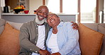 Senior couple, embrace and love on couch, support and commitment to marriage or happiness at home. Black elderly people, hugging and happy for bonding or loyalty in relationship, care and laughing