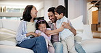 Home, happy family and parents tickle children, bonding and having fun together. Game, mother and father play with kids on sofa in living room, funny and laughing for care in healthy relationship