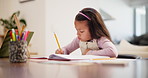 Homework, education and girl writing, knowledge and ideas with student and child development in a living room. Apartment, notebook and kid at a desk with a pencil and study for math and learning