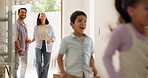 Parents, new home and children running, walking and excited for moving in, mortgage and real estate at entrance. Interracial family, mom and dad with kids in front door for dream house or property