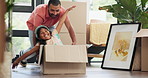 Box, moving and father playing with girl in new home for bonding, fun and quality time together. Happy, excited and young dad push child or kid in cardboard at modern apartment, house or property.