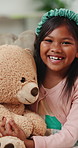 Smile, teddy bear and face of child on sofa playing and relaxing in living room at home. Happy, excited and portrait of girl kid holding a fluffy toy in lounge with positive attitude at house.