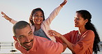 Family, parents and child on beach with piggyback game, support and adventure for freedom, love and care. Young mother, father and girl or kid laughing, playing and excited for holiday by the ocean