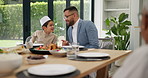 Family, child and food for eid al fitr celebration, Muslim people at dinner table together eating and talking. Islam, men and boy at Iftar with happy dad, son and culture festival of Ramadan in home 