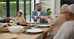 Muslim, family and friends with food or lunch at dining table for eid, islamic celebration or hosting. Ramadan, culture and children eating at religious gathering with dinner, discussion or happiness
