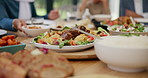 Table, healthy food or hands of family in home with lunch, drinks or celebration in social gathering event. Group of people, eating or plate closeup with dinner, meal or brunch with salad or bowl