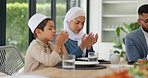 Muslim family, praying or dinner at table for Ramadan, Eid Mubarak or Iftar at home. Food, mother and father with child on Islamic holiday, eating or breaking fast together in celebration of religion