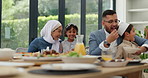 Muslim, parents and children with food or lunch at dining table for eid, islamic celebration or hosting. Ramadan, culture and people eating at religious gathering with dinner, discussion or happiness