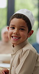 Child, face or muslim family at table in home with lunch, supper or celebration of Ramadan, fast or Eid. Portrait, happy boy eating or male kid with dinner, meal or food with feast, brunch or smile 