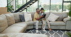 Tablet, learning or game with grandfather and boy on sofa in living room of home together for visit. Family, technology or social media app with elderly man and grandson in apartment for education