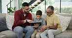 Grandfather, dad and son with tablet on sofa in living room of home together for visit. Family, technology or social media app with senior man, parent and grandson in apartment for education or game