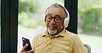 Senior man, headphones and streaming song on phone, playlist and subscription to app for audio. Asian male person, dancing and reading news on mobile app, podcast and techno song for fun on weekend
