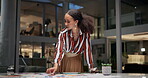 Fashion, designer and woman organising and pressing on paperwork or document in her studio. Fashion designer, creative studio and female organising her desk and creative designs in her office 