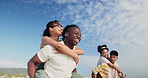 Outdoor, couple and piggy back with a date, people and friends with happiness and bonding together. Nature, men carrying women and relationship with vacation and wind with summer break and love