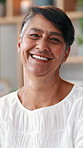 Face, laughing and senior woman in home living room, smile and bokeh in retirement in house. Portrait, funny and happy elderly female person with positive facial expression in apartment in Brazil