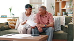 Frustrated, senior and couple with documents on sofa in financial crisis, fight or conflict for bills or expenses at home. Mature man and woman with paperwork in argument, disagreement or stress