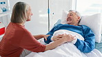 Elderly couple, husband and talking in hospital bed or happy connection for good news, checkup or visit. Wife, man and smile for wellness at clinic or conversation for marriage, love or healthcare