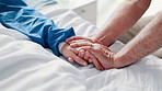 Patient, person and hand holding on hospital bed for support or empathy for health problem, diagnosis or virus. People, fingers and embrace for difficult news or marriage compassion, unity or care