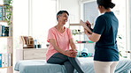 Mature, checklist or happy woman in consultation for physiotherapy with results, news or clipboard. Rehabilitation, smile or patient talking for trauma evaluation with a physiotherapist writing notes