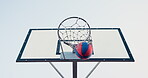 Basketball, net and shot for success outside with a competitive sport for athletics. Below, ball and fitness game with a hoop for scoring and training for health and wellness with equipment outdoors